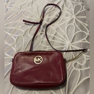 Women’s red Michael Kors small purse and leather